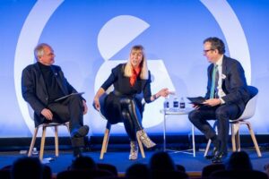 From left: Paul Polman, former CEO of Unilever; Caroline Casey, founder of #valuable and The Valuable 500, and Michael Hayman, founder of Seven Hills, on stage at the AWE.